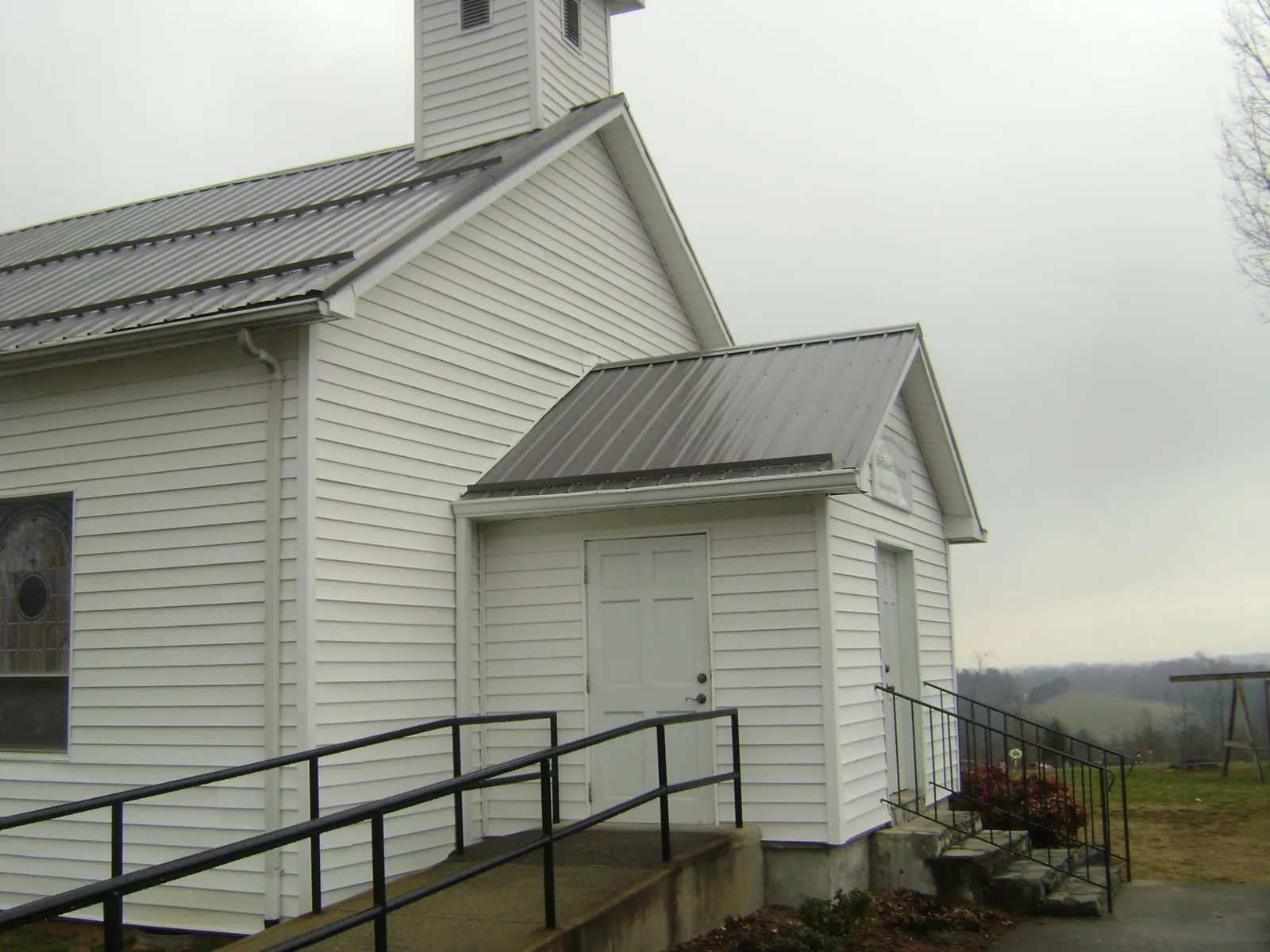 Gray metal roof on a white clapboard church with a steeple in Pomfret